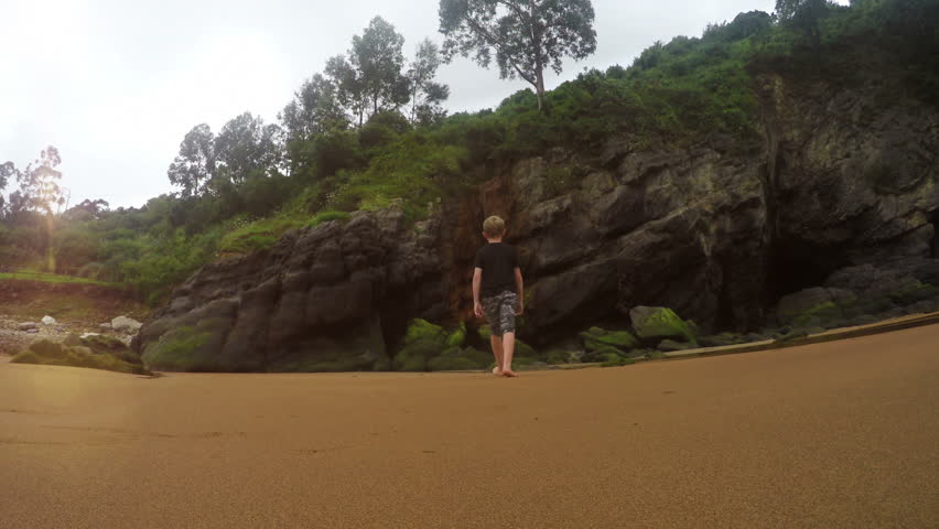 4K footage of mother and son on a sandy beach