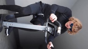 man on an exercise bike vertical video