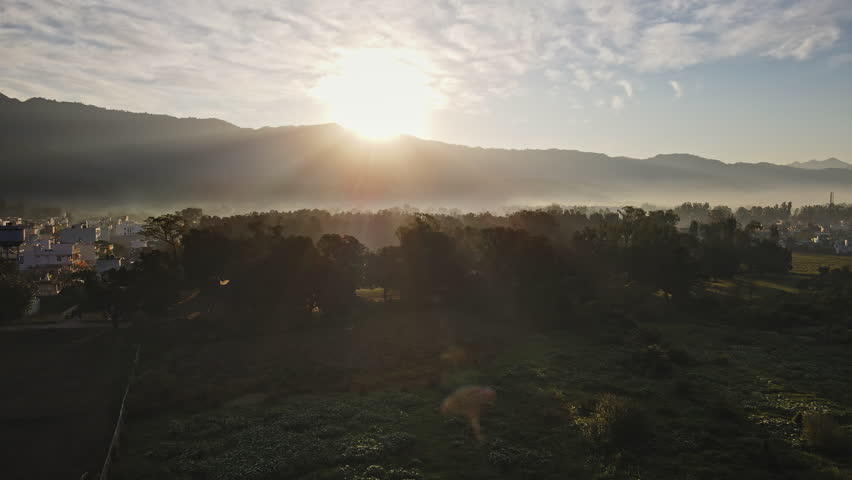 Beautiful shot of sunrise in the misty morning. Aerial view of yoga capital city Rishikesh on a winter morning. Royalty-Free Stock Footage #3401718031