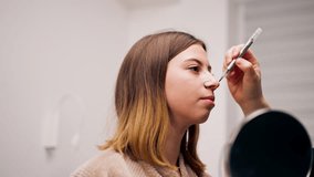 close-up plastic surgeon makes marks on a patient's face during a consultation before nose operation - Powered by Shutterstock - Get 15% off with code: PIKWIZARD15