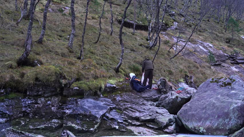 Person packing meat in backpack after succesful hunt in afternoon