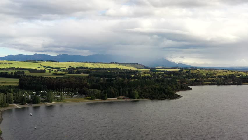 Lake Te Anau at Te Anau town in aerial panorama of New Zealand fiordland as 4k.
