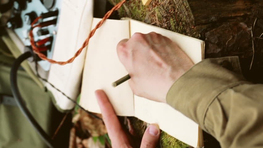 Russian Soviet Infantry Red Army Soldier In World War II using Russian Soviet Portable Radio Transceiver In Trench Entrenchment In Spring Autumn Forest. vertical. Headphones And Telegraph Key. Close
