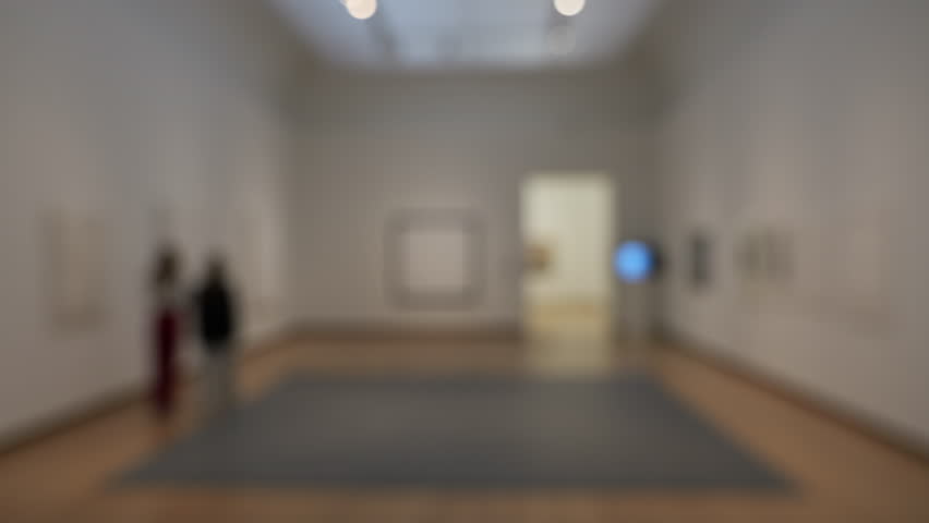 Interior museum: large room with modern art and visitors. Soft focus.