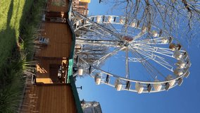 Ferris wheel at the Christmas market in the center of Bergamo, Italy. Vertical video. 22.12.2023