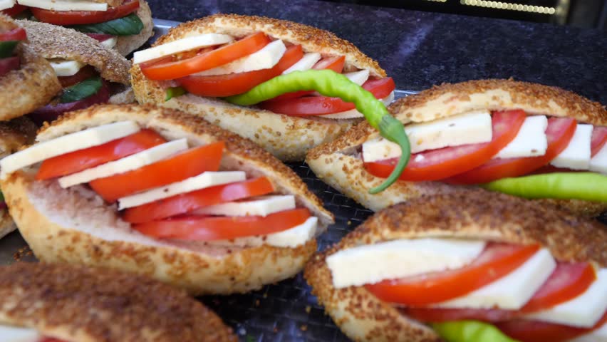 Traditional delicious Turkish street food; Izmir cesme kumru sandwich made of cheese, soudjouk, salami, soudjouk, tomato and pepper