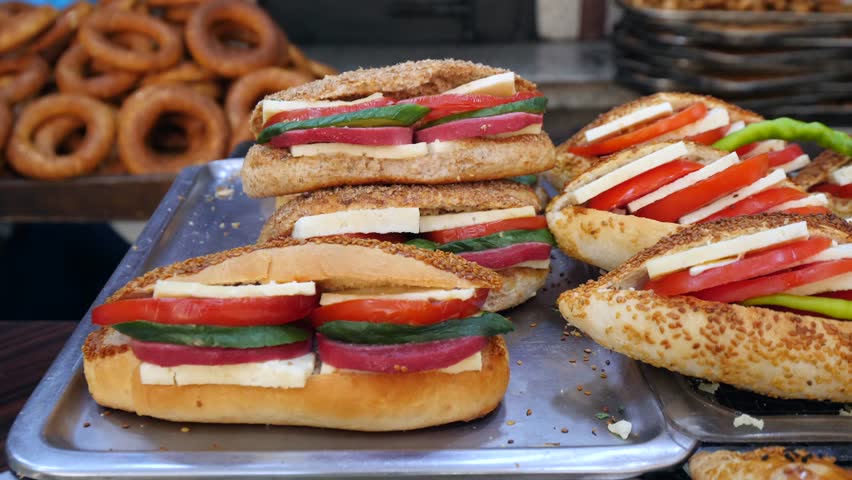 Traditional delicious Turkish street food; Izmir cesme kumru sandwich made of cheese, soudjouk, salami, soudjouk, tomato and pepper