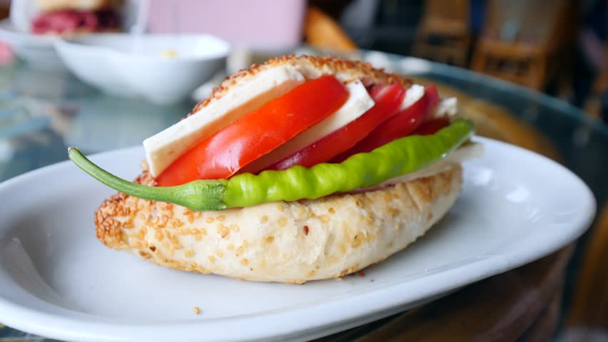 Traditional delicious Turkish street food; Izmir cesme kumru sandwich made of cheese, soudjouk, salami, soudjouk, tomato and pepper