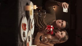 Couple in love taking selfie while having dinner in restaurant or at home celebrating valentine's day or anniversary - Powered by Shutterstock - Get 15% off with code: PIKWIZARD15