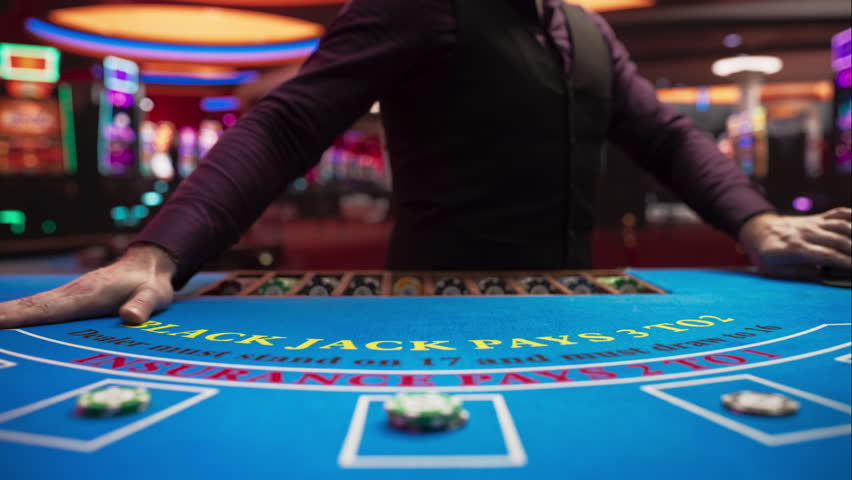 Online Casino: Professional Croupier Deals Cards on Blackjack Table: Anonymous Male Game Dealer Masterfully Revealing possible Jackpot Winning Hand, Excitement in High Stakes Game. Closeup Static shot Royalty-Free Stock Footage #3401941083