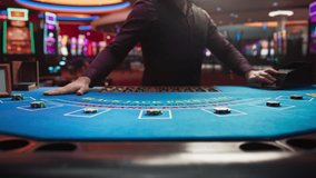 Casino Card Game Table: Professional Dealer Running a Blackjack Game. Anonymous Male Croupier Dealing Playing Cards for Placed Bets. Betting on Payout, Strategy and Luck. Zoom in Cinematic Shot