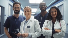 Healthcare Crew: Team Portrait of a Female and Male Successful Diverse Medical Healthcare Professionals Standing as a Group in a Modern Hospital Office, Posing, Looking at Camera and Smiling - Powered by Shutterstock - Get 15% off with code: PIKWIZARD15