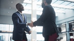 Male Business Partners Meet in Office, Shake Hands. Corporate CEO and Finance Manager Have Meeting in City Office. Businesspeople Came to Discuss Real Estate Purchase and Project. Slow Motion - Powered by Shutterstock - Get 15% off with code: PIKWIZARD15