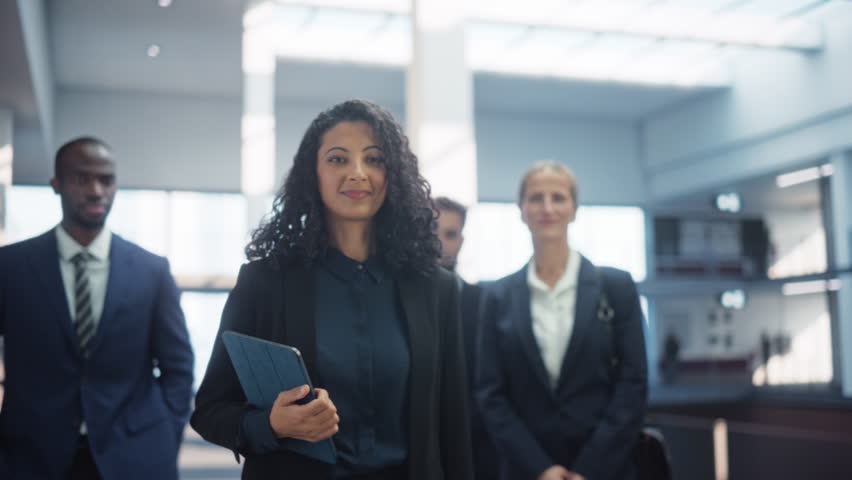 Posing Shot of a Diverse Group of Talented Young Business People Standing in the Modern Office Environment. Successful Team Smiling on Camera, Led by a Confident Female CEO. Slow Motion Royalty-Free Stock Footage #3401973495