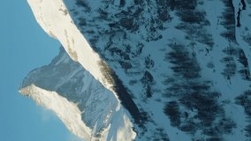 Matterhorn Mountain in Winter Day. Switzerland. Aerial View. Medium Shot. Drone Flies Sideways, Camera Tilts Up. Vertical Video