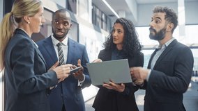 Diverse Team of Professional Businesspeople Meeting in the Office Building. Creative Team Gathering Together, Group of Young Entrepreneurs Using Laptop Computer, Speak About Marketing Compain - Powered by Shutterstock - Get 15% off with code: PIKWIZARD15