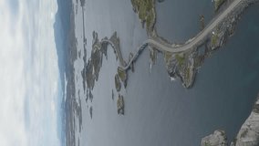 Atlantic Ocean Road in Norway from High Altitude. Aerial View. Drone Orbits Around. Vertical Video