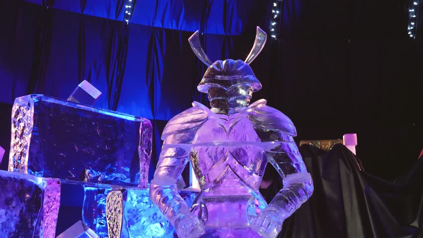 Ice sculpture of a medieval knight with shield, ice carving sculpture during winter holidays