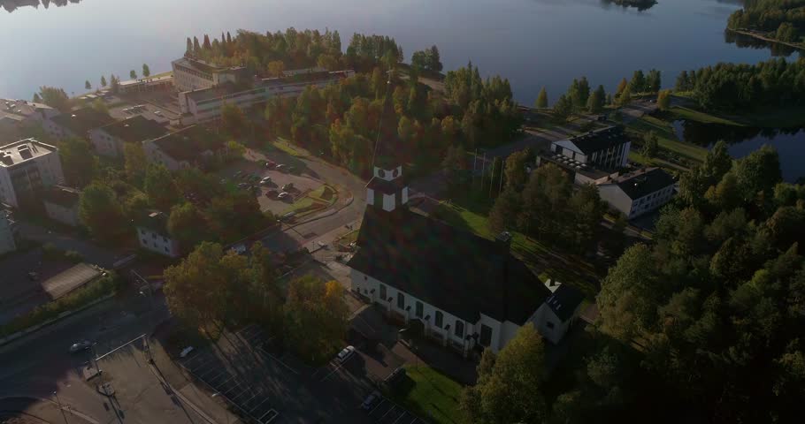 Arctic church, Cinema 4k aerial tilt view away from a church, revealing kemijoki river, in Rovaniemi city, on a sunny autumn morning dawn, in Lapland, Lappi, Finland