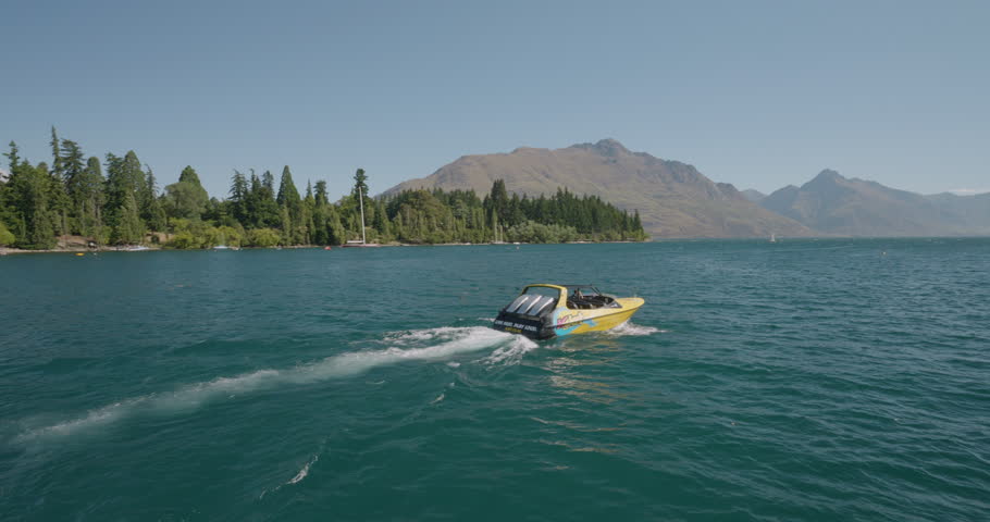 Slow Motion Of Shotover Jet Boat Cruising Across Wakatipu Lake In Queenstown, New Zealand. pan right shot