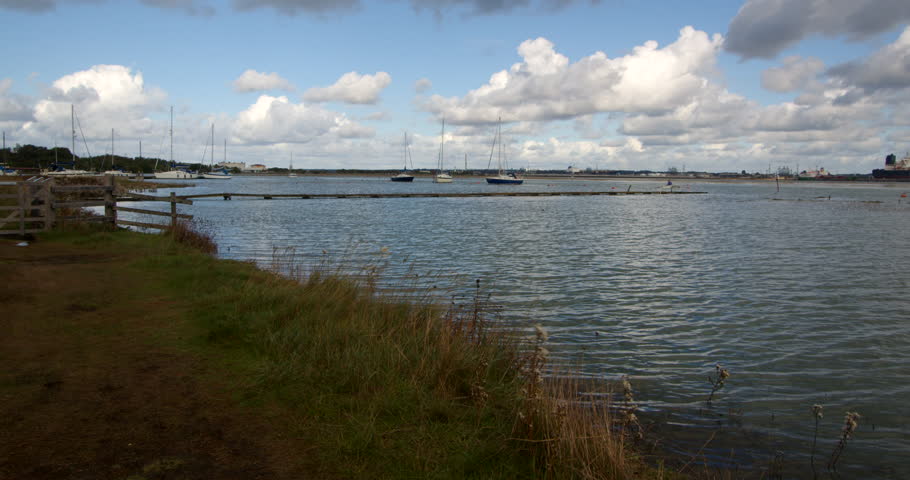 Extra wide shot looking north of the Solent at high tide. Taken at Ashlett creek sailing club in the Solent, Southampton Royalty-Free Stock Footage #3402112913