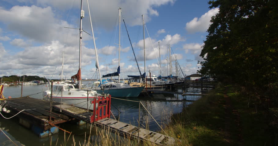 sailboats moored up at high tide at Ashlett creek sailing club in the Solent, Southampton Royalty-Free Stock Footage #3402113617
