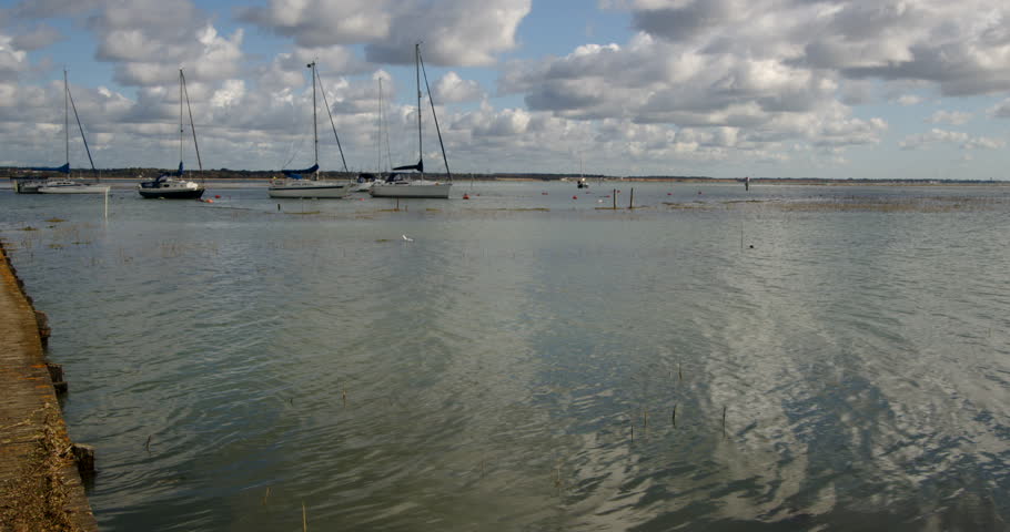 wide shot looking north of the Solent at high tide. Taken at Ashlett creek sailing club in the Solent, Southampton Royalty-Free Stock Footage #3402115677