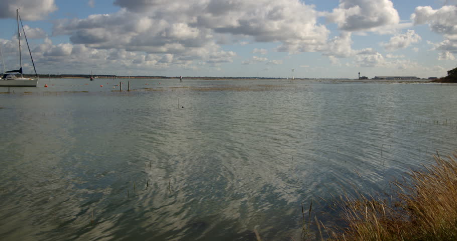 wide shot looking north of the Solent at high tide. Taken at Ashlett creek sailing club in the Solent, Southampton Royalty-Free Stock Footage #3402118345