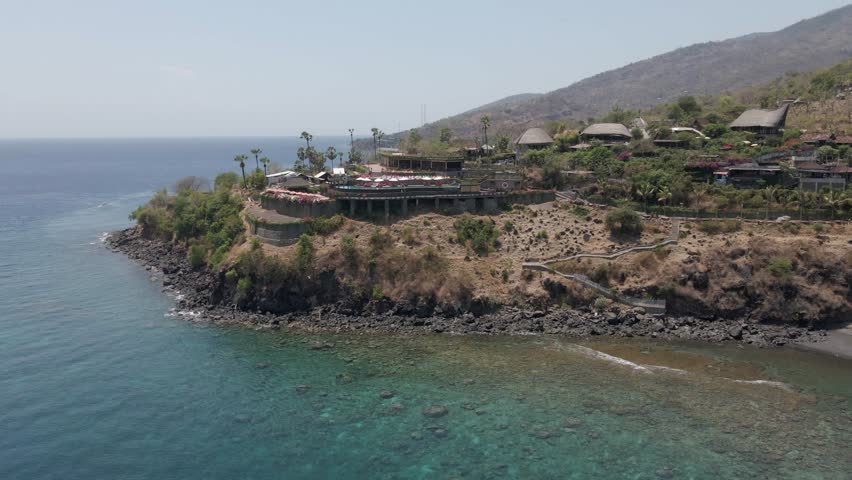 Sunset Point Amed Bali restaurant on promontory over rocky beach