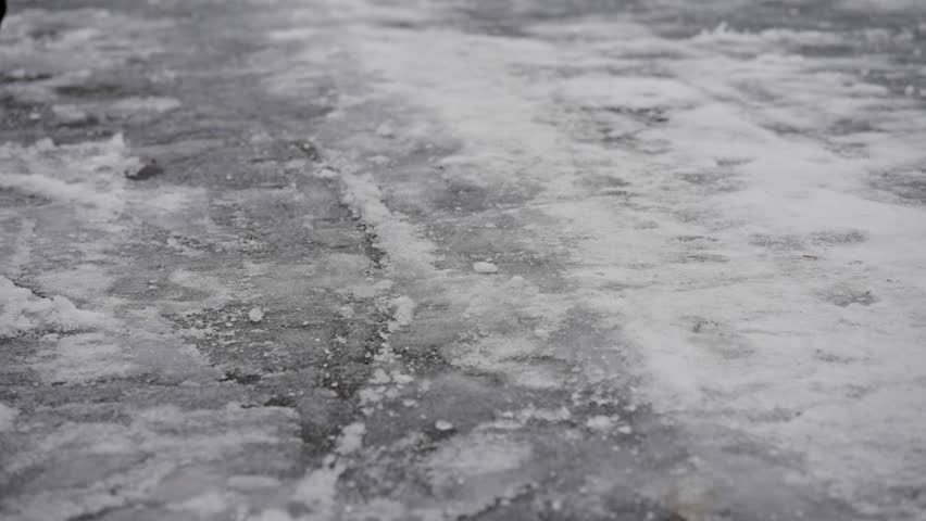 Adult man walking an icy surface slips, falls on backside, slow motion Royalty-Free Stock Footage #3402168361