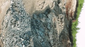 Camera slides slowly across quarry highlighting mining in natural environment Quarry landscape showcased in slow motion focusing on resource extraction Quarry panorama reveals minings impact on nature