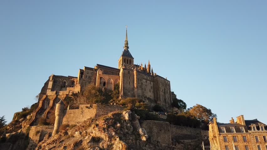 The Mont Saint Michel at the sunset. The Abbey of Mont-Saint-Michel in Normandy, France.
