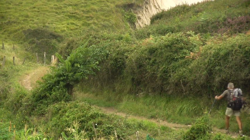 Man and woman hiking through field