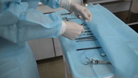 Dentist and assistant with Dental drill, syringe, dental mirror and other dental equipment before surgery wisdom tooth extraction in professional dental clinic. 4k raw cinematic slow motion video