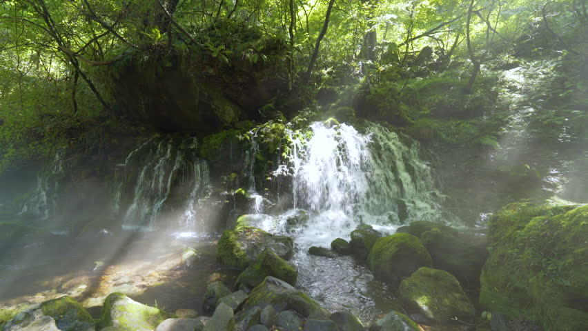 Cinematic gimbal shot of misty Mototaki Fukuryusui Underflow waterfalls in Akita prefecture in Japan