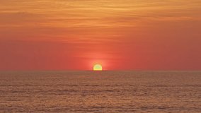 .Stunning the sun is setting on the horizon. Yellow sun in a crimson sky..The astonishing beauty of nature of seascape..beautiful sky at sunset or sunrise in nature and travel concept.