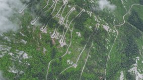 Lovcen Road in Montenegro through this stunning drone video. Witness the serpentine road winding elegantly through the lush Lovcen National Park. Thrilling zigzags amidst mountainous landscapes.