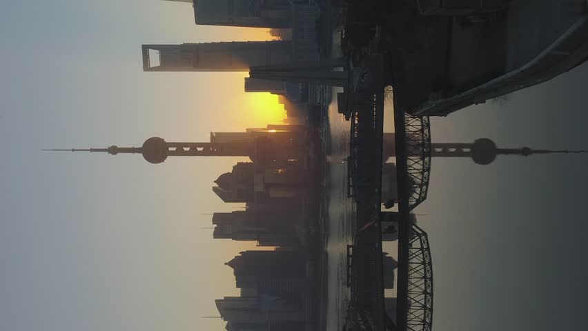 Panoramic Shanghai Skyline at Sunrise. Lujiazui Financial District and Huangpu River. China. Aerial View. Drone is Flying Forward and Upward. Establishing Shot. Vertical Video Royalty-Free Stock Footage #3402491913