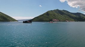 Saint George Island and Church of Our Lady of the Rocks in Perast, Montenegro. Our Lady of the Rock island and Church in Perast In Kotor Bay Montenegro, Europe. 4K Drone Footage.