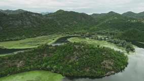 Aerial footage captures the stunning view of the horseshoe-shaped river bend at Pavlova Strana near Skadar Lake in Montenegro. The footage provides a mesmerizing view of the natural beauty in 4K. 