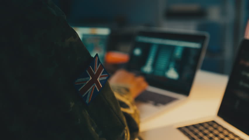 British intelligence officer working laptop in office, gathering intel on enemy Royalty-Free Stock Footage #3402494415