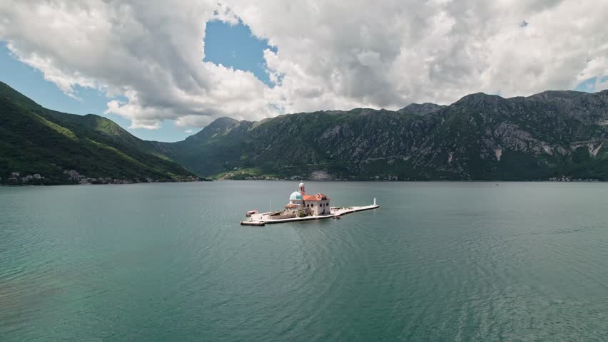 Saint George Island and Church of Our Lady of the Rocks in Perast, Montenegro. Our Lady of the Rock island and Church in Perast In Kotor Bay Montenegro, Europe. 4K Drone Footage.