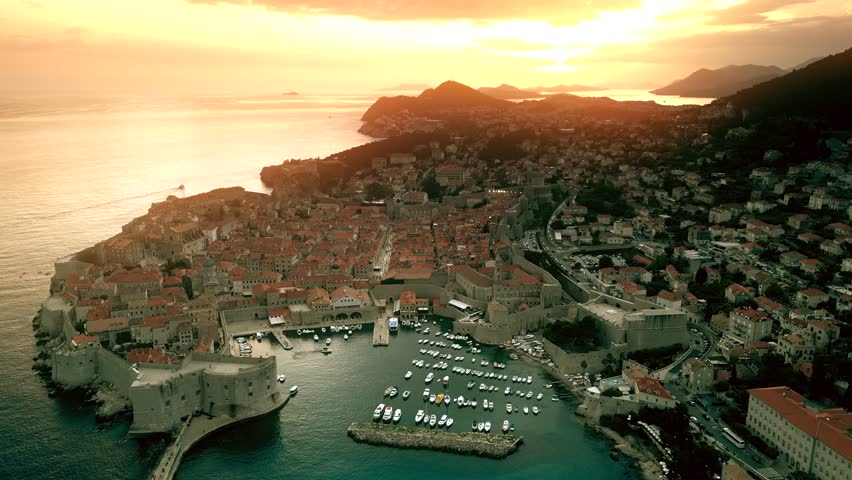 Beautiful sunset over Dubrovnik Old Town and marina, Croatia. Aerial view