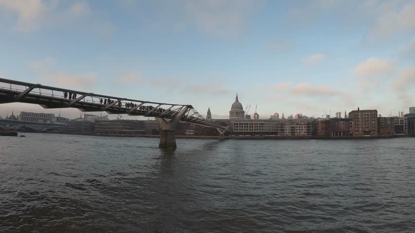 PAN SLOW MOTION SHOT - St Paul's Cathedral and The Millennium Bridge, London, England, United Kingdom. Royalty-Free Stock Footage #3402572039