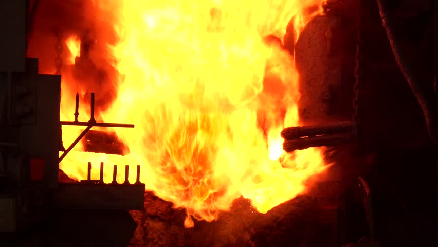 Blast furnace smelting liquid steel in steel mills.  Metal smelting furnace in steel mills. Pouring of liquid metal in open-hearth furnace. Metallurgi