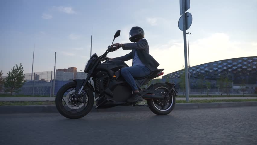 Caucasian man rides on an electric motorcycle. 