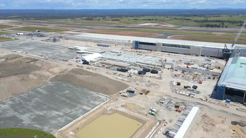 Aerial drone pullback reverse view of the construction site of the new Western Sydney International Airport at Badgerys Creek in Western Sydney, NSW on a sunny day shot on 23 December 2023 Royalty-Free Stock Footage #3402667519