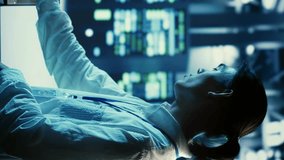 Vertical video Technicians programming in server room housing advanced infrastructure storing massive datasets. Workers running code on laptop to upgrade data center racks doing complex computational - Powered by Shutterstock - Get 15% off with code: PIKWIZARD15