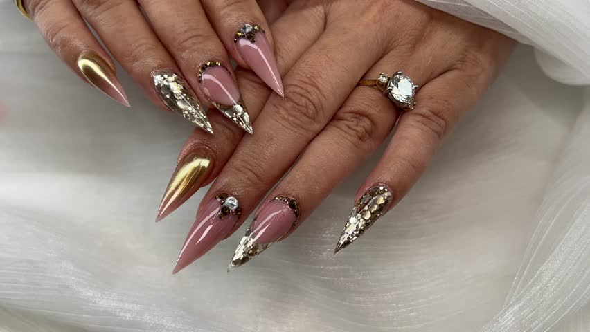 Stunning Stiletto Nails: Ombre, Glitter, and Rhinestone Nail Art. Watch as ombre hues, glitter, and rhinestones come together in a dazzling display of nail art mastery.  Royalty-Free Stock Footage #3402679305