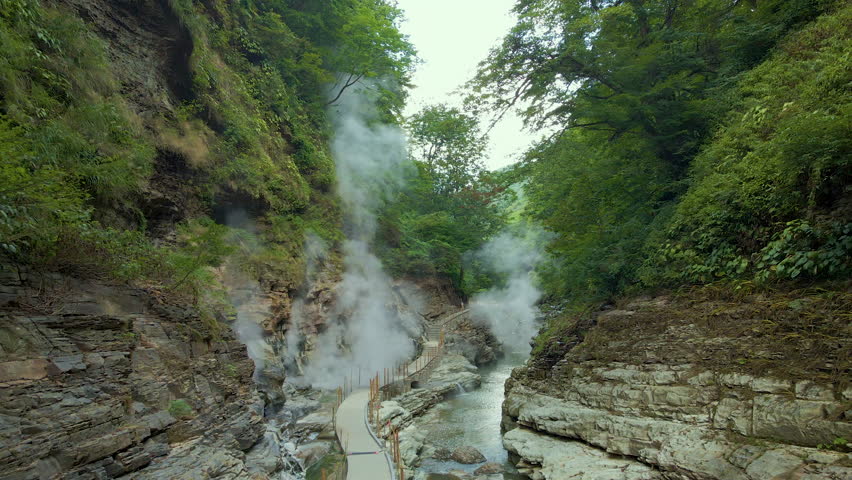 Cinematic aerial shot of steam vents at Oyasukyo Gorge in Akita prefecture in Japan Royalty-Free Stock Footage #3402686897